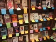 Books with handwritten notes by the shop staff